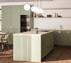 A modern kitchen with olive-green drawers made from FSC certified Birch plywood, a central island, and hanging white pendant lights. The room features wood flooring and a minimalist design.