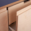 Close-up view of a plyzen B/BB grade birch plywood desk with an open drawer, showcasing layers of wood grain and precise craftsmanship.